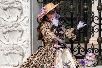 People in costume at the Venice Carnival in front of the Venetian Arsenal.