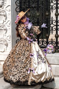 People in costume at the Venice Carnival in front of the Venetian Arsenal.