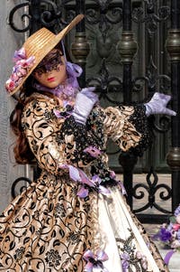 People in costume at the Venice Carnival in front of the Venetian Arsenal.