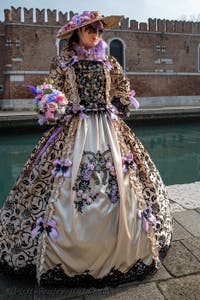 People in costume at the Venice Carnival in front of the Venetian Arsenal.