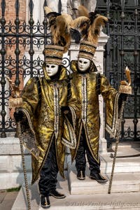 People in costume at the Venice Carnival in front of the Venetian Arsenal.