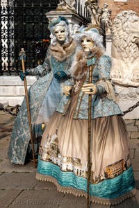 People in costume at the Venice Carnival in front of the Venetian Arsenal.