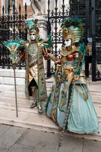 People in costume at the Venice Carnival in front of the Venetian Arsenal.