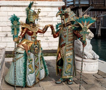 People in costume at the Venice Carnival in front of the Venetian Arsenal.