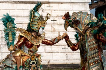 People in costume at the Venice Carnival in front of the Venetian Arsenal.