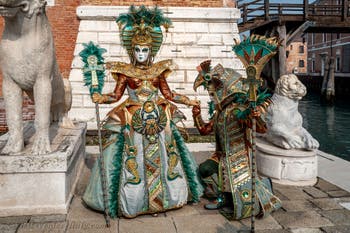 People in costume at the Venice Carnival in front of the Venetian Arsenal.