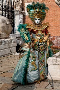 People in costume at the Venice Carnival in front of the Venetian Arsenal.