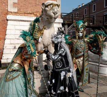 People in costume at the Venice Carnival in front of the Venetian Arsenal.