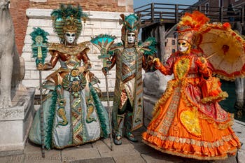 People in costume at the Venice Carnival in front of the Venetian Arsenal.