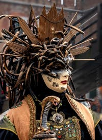 People in costume at the Venice Carnival in front of the Venetian Arsenal.