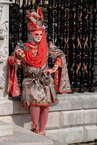 People in costume at the Venice Carnival in front of the Venetian Arsenal.