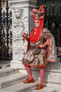 People in costume at the Venice Carnival in front of the Venetian Arsenal.