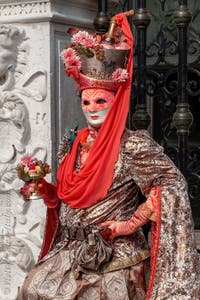 People in costume at the Venice Carnival in front of the Venetian Arsenal.