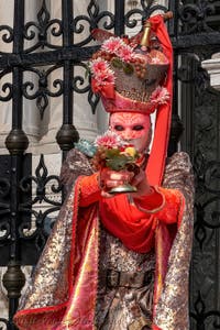 People in costume at the Venice Carnival in front of the Venetian Arsenal.