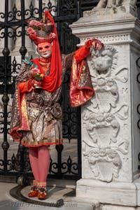 People in costume at the Venice Carnival in front of the Venetian Arsenal.