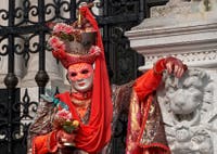 People in costume at the Venice Carnival in front of the Venetian Arsenal.