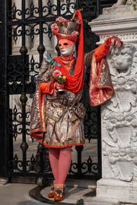 People in costume at the Venice Carnival in front of the Venetian Arsenal.