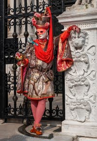 People in costume at the Venice Carnival in front of the Venetian Arsenal.