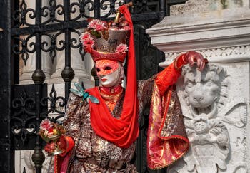 People in costume at the Venice Carnival in front of the Venetian Arsenal.