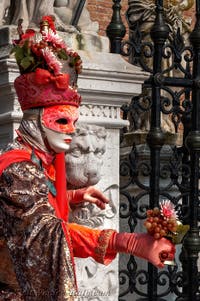 People in costume at the Venice Carnival in front of the Venetian Arsenal.