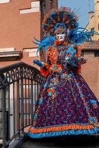 People in costume at the Venice Carnival in front of the Venetian Arsenal.