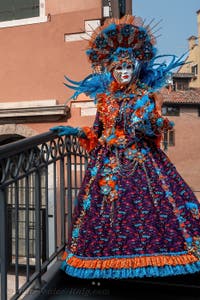 People in costume at the Venice Carnival in front of the Venetian Arsenal.