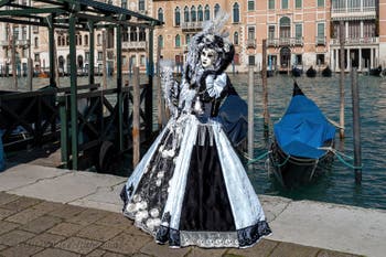 People in costume at the Venice carnival in front of the Madonna della Salute.