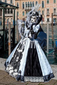 People in costume at the Venice carnival in front of the Madonna della Salute.