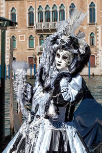 People in costume at the Venice carnival in front of the Madonna della Salute.