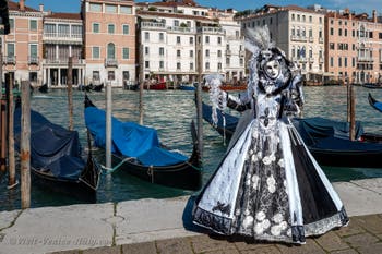 People in costume at the Venice carnival in front of the Madonna della Salute.