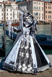 People in costume at the Venice carnival in front of the Madonna della Salute.