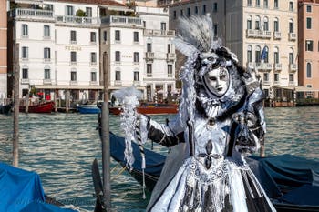 People in costume at the Venice carnival in front of the Madonna della Salute.