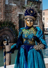 People in costume at the Venice carnival in front of the Madonna della Salute.