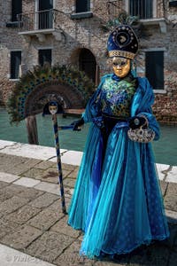 People in costume at the Venice carnival in front of the Madonna della Salute.