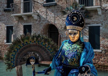 People in costume at the Venice carnival in front of the Madonna della Salute.