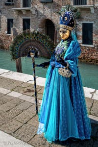 People in costume at the Venice carnival in front of the Madonna della Salute.