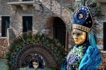 People in costume at the Venice carnival in front of the Madonna della Salute.