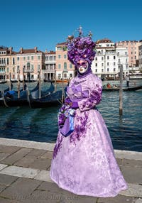 People in costume at the Venice carnival in front of the Madonna della Salute.