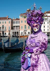 People in costume at the Venice carnival in front of the Madonna della Salute.