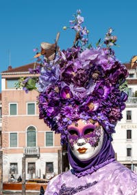 People in costume at the Venice carnival in front of the Madonna della Salute.