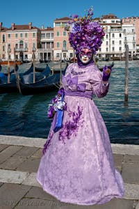 People in costume at the Venice carnival in front of the Madonna della Salute.