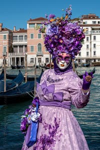 People in costume at the Venice carnival in front of the Madonna della Salute.