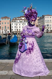 People in costume at the Venice carnival in front of the Madonna della Salute.