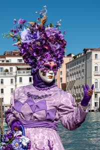 People in costume at the Venice carnival in front of the Madonna della Salute.