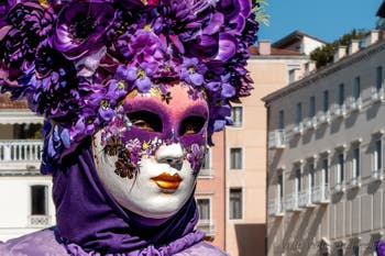 People in costume at the Venice carnival in front of the Madonna della Salute.