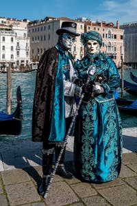 People in costume at the Venice carnival in front of the Madonna della Salute.