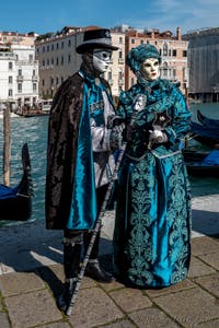 People in costume at the Venice carnival in front of the Madonna della Salute.