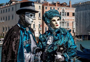 People in costume at the Venice carnival in front of the Madonna della Salute.