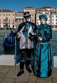 People in costume at the Venice carnival in front of the Madonna della Salute.