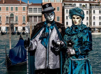 People in costume at the Venice carnival in front of the Madonna della Salute.